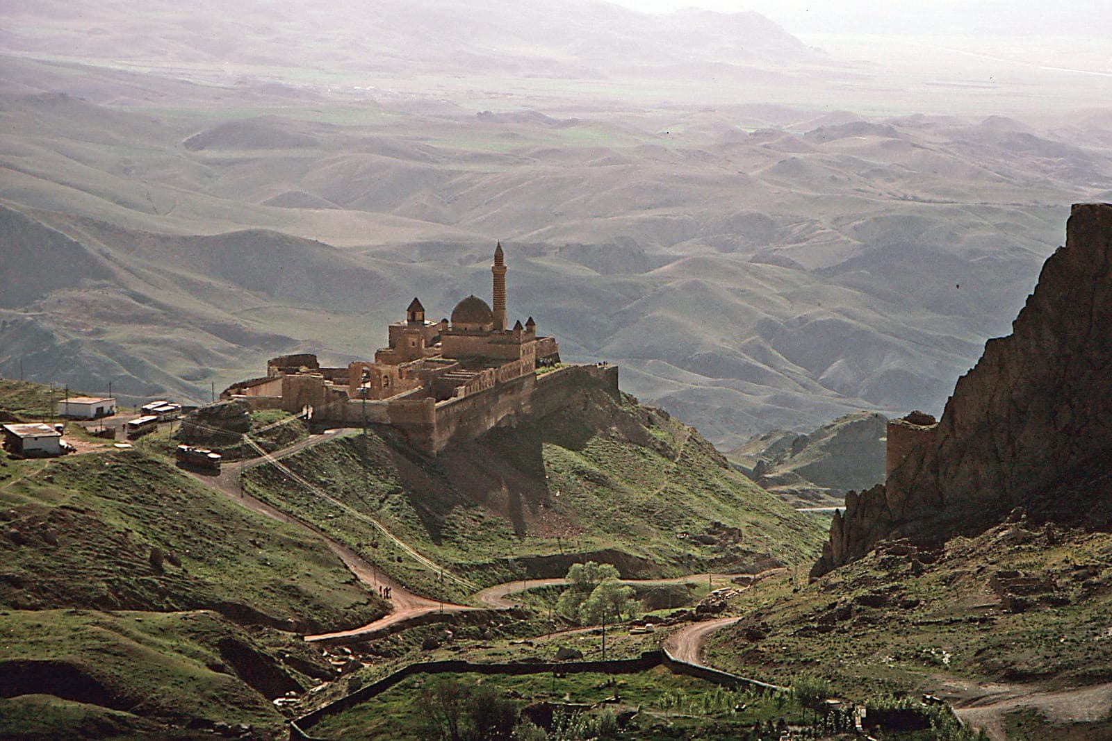 Ishak Pasha Palace with snow-capped mountains in the background