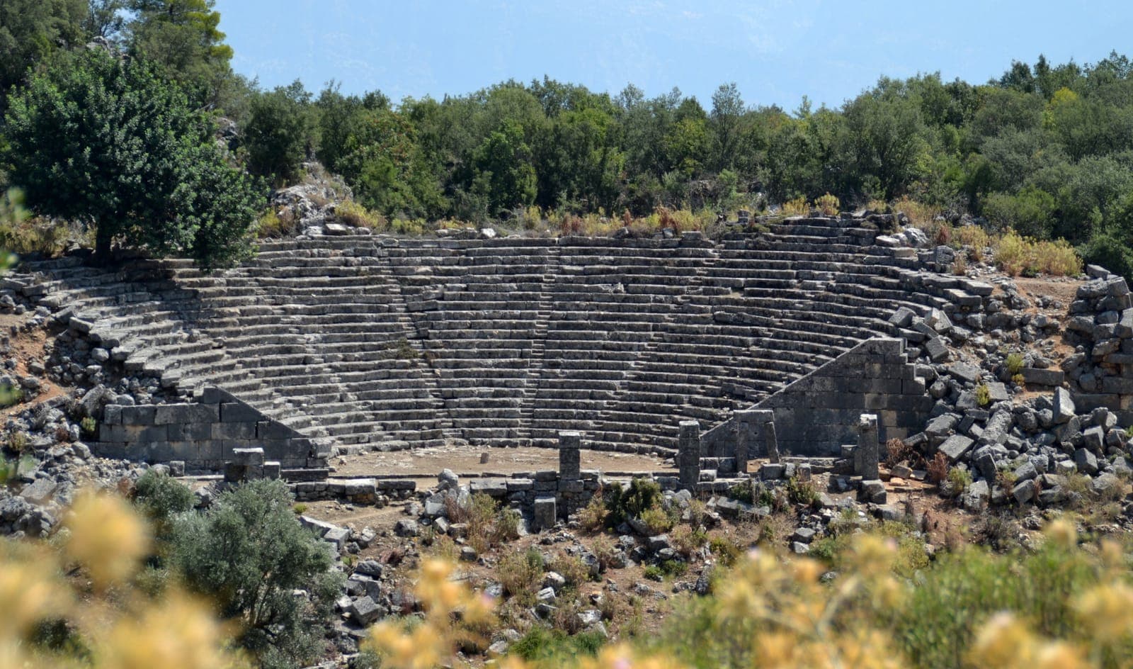 Theatre at Pinara with dramatic cliff face of rock tombs behind