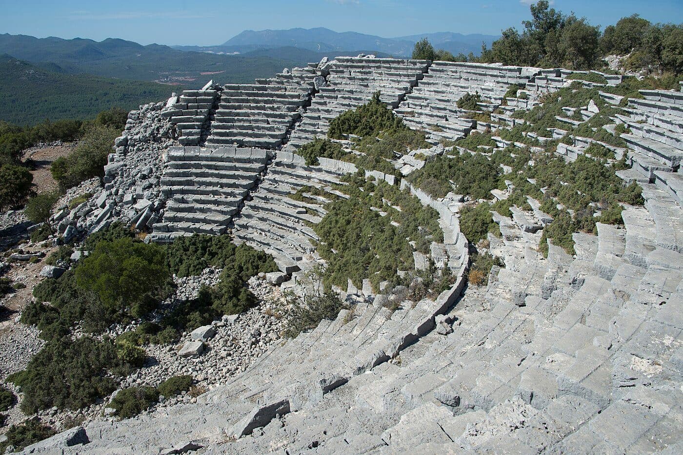Lycian sarcophagi standing among the ruins of Cyaneae with mountains in the background