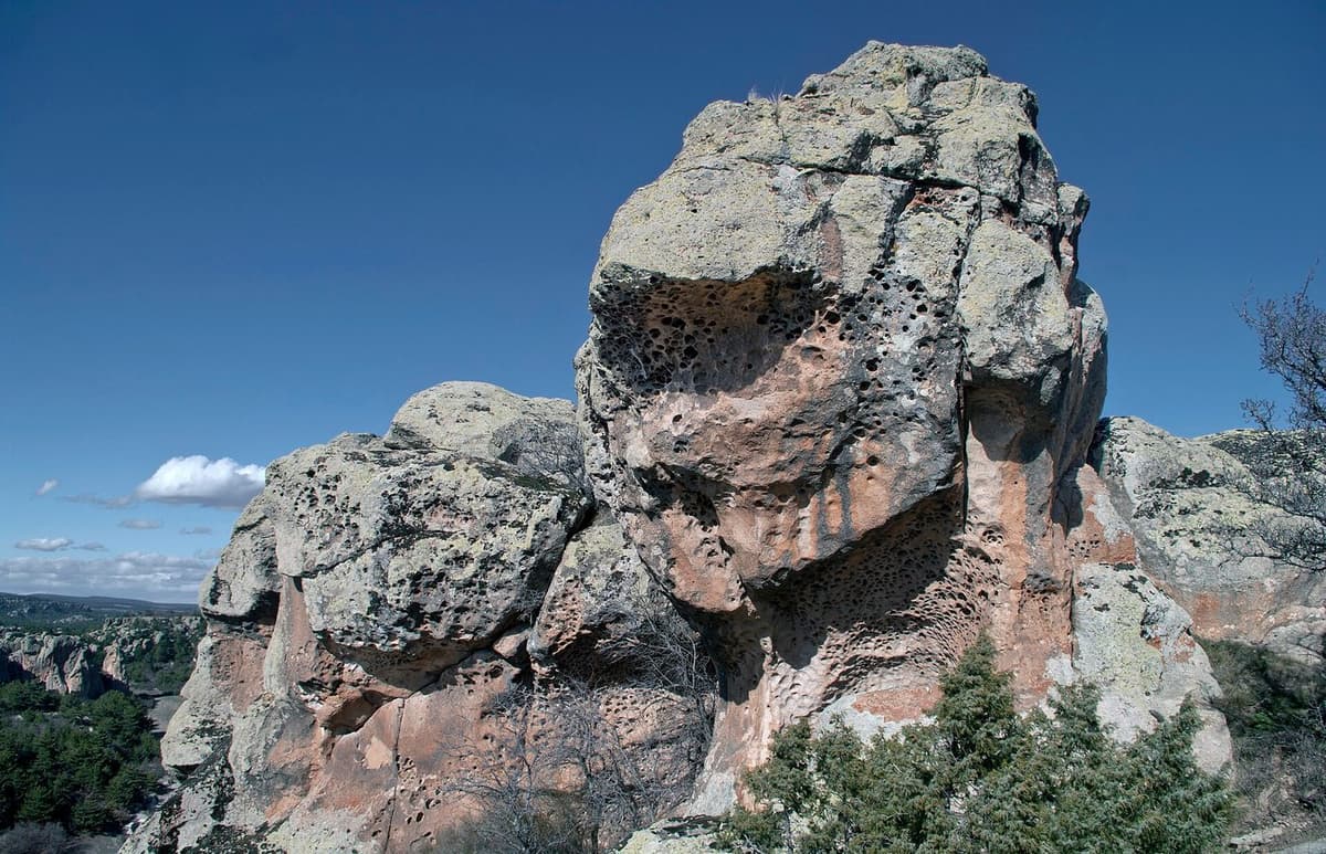 The vast, intricately carved geometric facade of the Midas Monument rock-cut sanctuary against a sky backdrop.